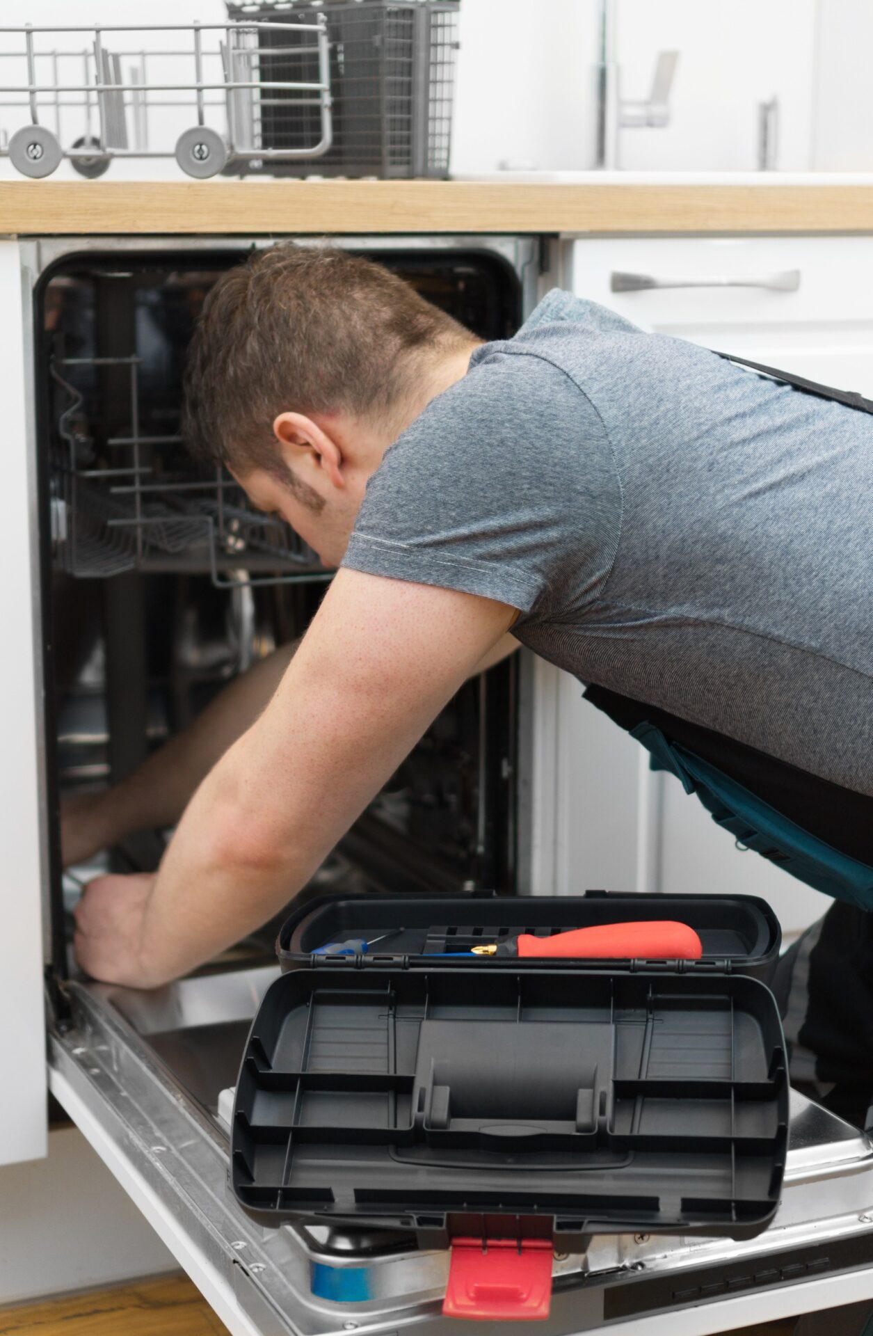 dish-washer man fixing a dish washer
